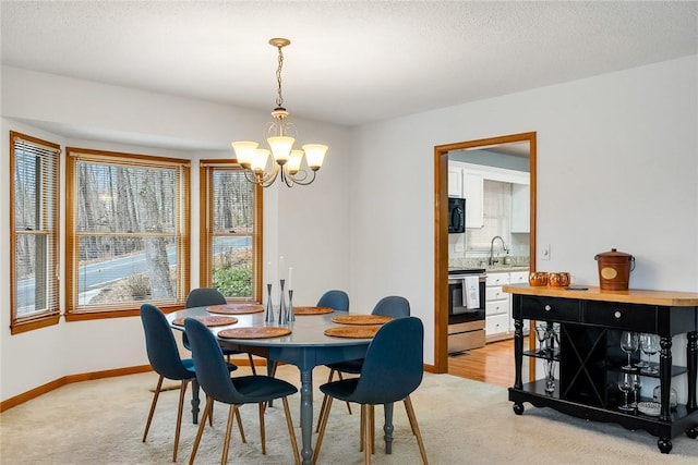 dining area with baseboards, light carpet, and a chandelier