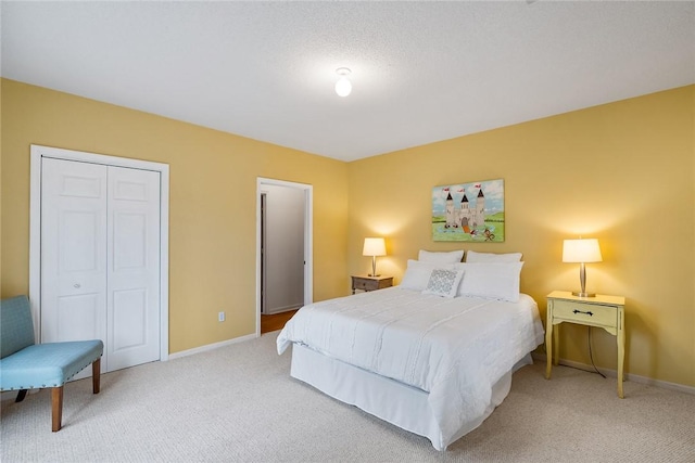 bedroom with baseboards, light carpet, and a closet