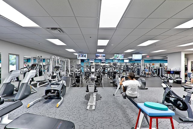 workout area with visible vents and a paneled ceiling