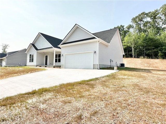 view of front facade featuring a porch, a garage, and driveway