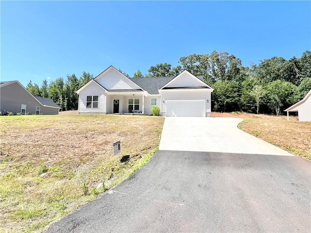 ranch-style home featuring an attached garage, driveway, and a front lawn