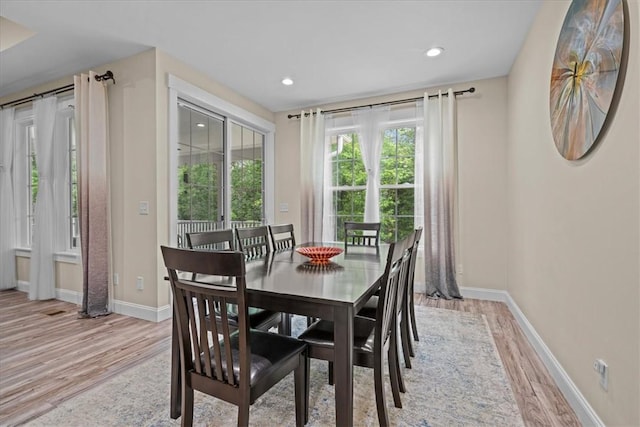 dining room with recessed lighting, baseboards, and light wood-style flooring