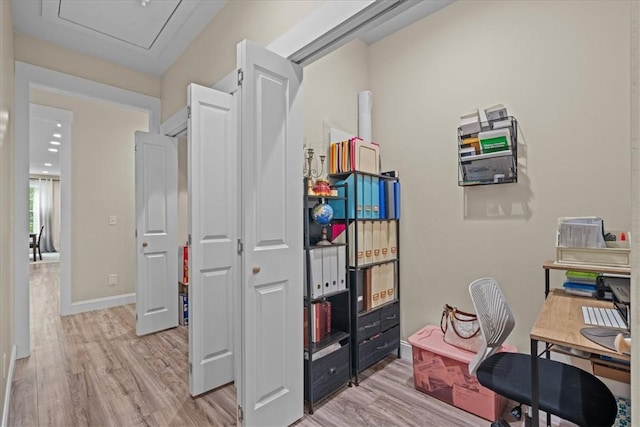 office space with baseboards and light wood finished floors