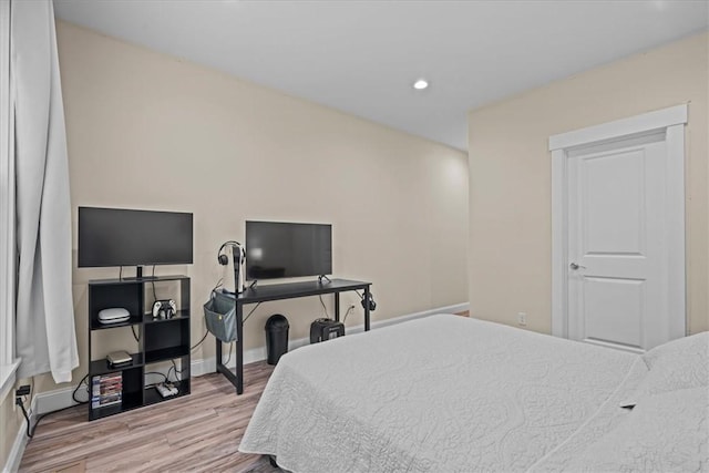 bedroom with baseboards, recessed lighting, and wood finished floors