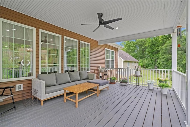 wooden deck featuring an outdoor living space and ceiling fan
