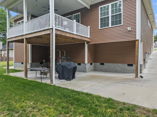 back of property featuring a patio, a lawn, and crawl space