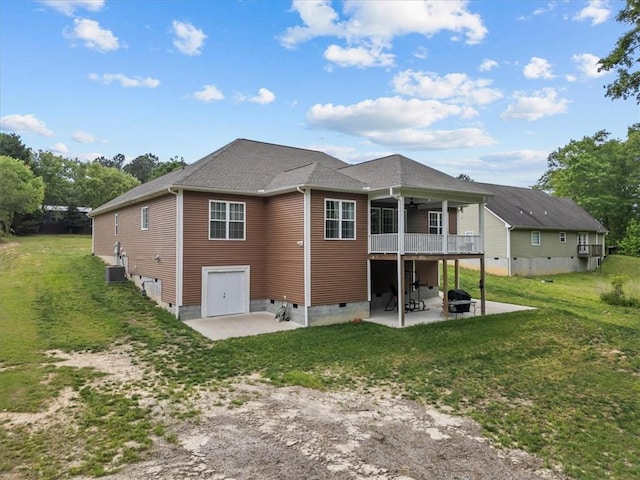 rear view of house with crawl space, ceiling fan, central AC unit, a patio area, and a yard