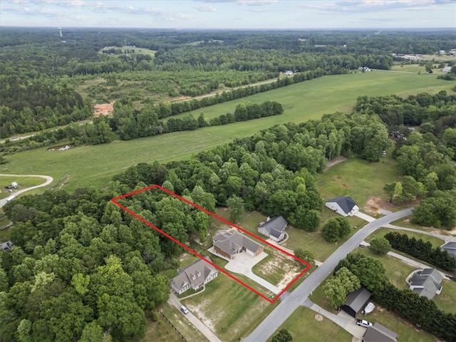 drone / aerial view with a wooded view