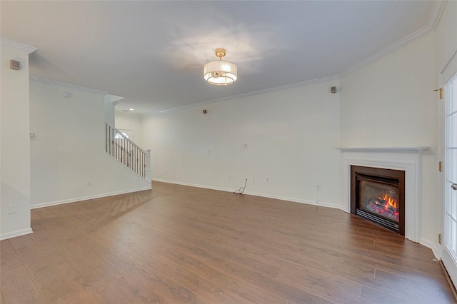 127 Ledgewood Way, Easley, SC 29642 - unfurnished living room featuring crown molding, a glass covered fireplace, baseboards, wood finished floors, and stairway