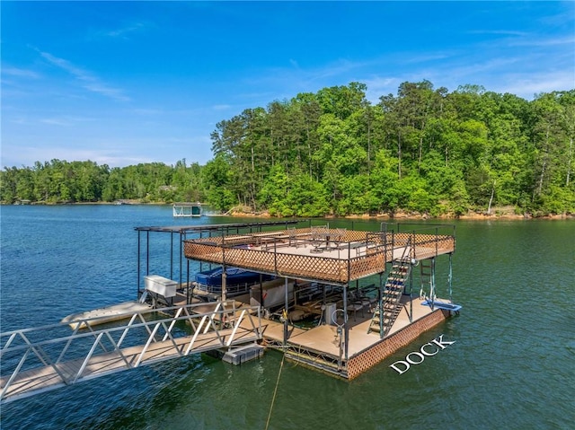 dock area featuring a water view and a wooded view