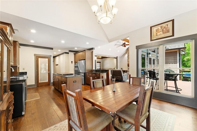 dining space with recessed lighting, dark wood-type flooring, lofted ceiling, and ceiling fan with notable chandelier