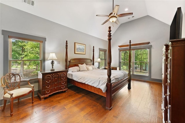 bedroom with a ceiling fan, wood-type flooring, visible vents, and high vaulted ceiling