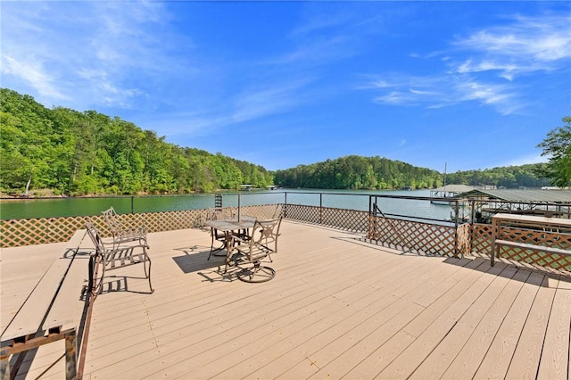 deck with a water view and a forest view