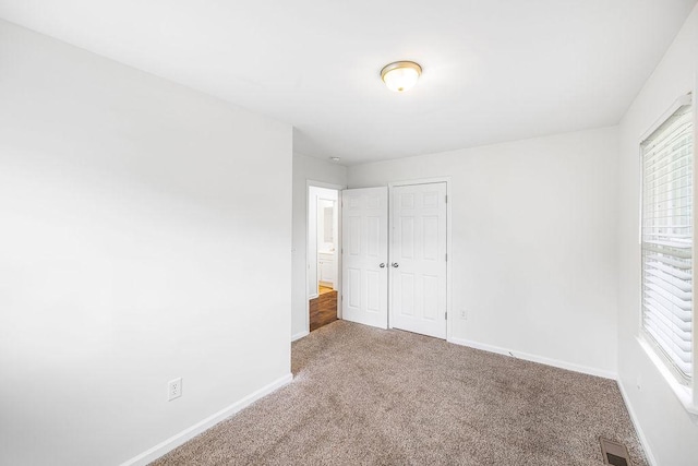 116 Ashley Dr, Pelzer, SC 29669 - unfurnished bedroom with baseboards, multiple windows, and carpet floors