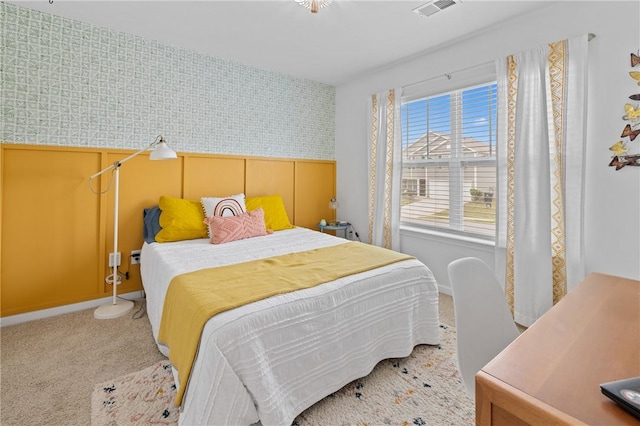bedroom featuring carpet, baseboards, visible vents, and wallpapered walls