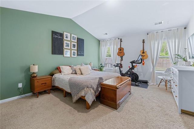 bedroom with light colored carpet, multiple windows, and lofted ceiling