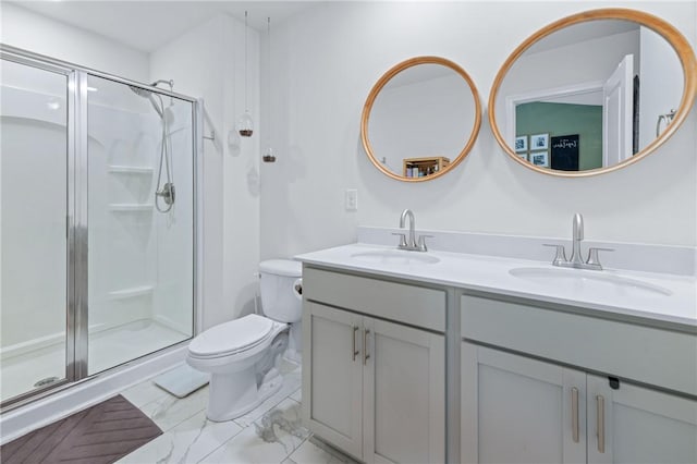 bathroom featuring double vanity, toilet, a stall shower, and a sink
