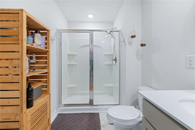 full bathroom with vanity, marble finish floor, a stall shower, and toilet