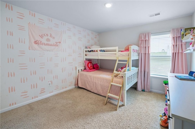 carpeted bedroom featuring baseboards, visible vents, and wallpapered walls