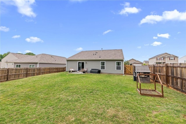 rear view of house with a lawn, a patio area, and a fenced backyard