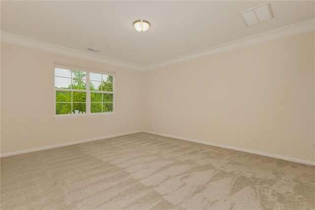 empty room featuring crown molding, carpet flooring, and baseboards