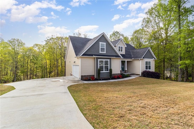 view of front of property featuring concrete driveway, a garage, and a front yard