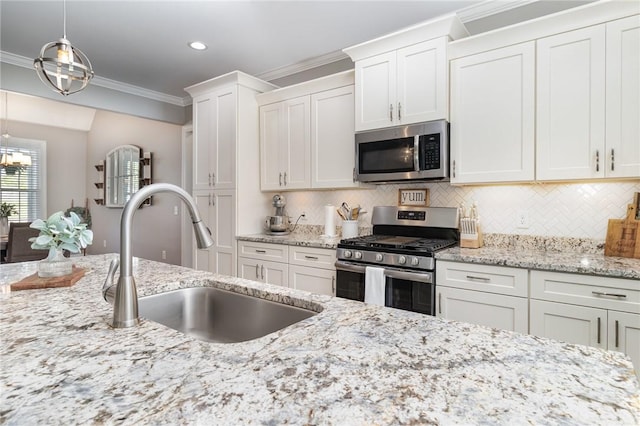 kitchen with a sink, crown molding, white cabinetry, and appliances with stainless steel finishes