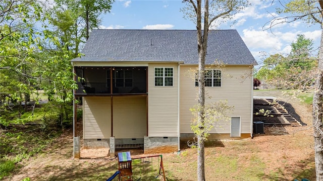 rear view of house featuring cooling unit, a shingled roof, a sunroom, and crawl space