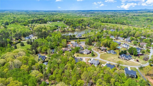 bird's eye view with a water view, a forest view, and a residential view