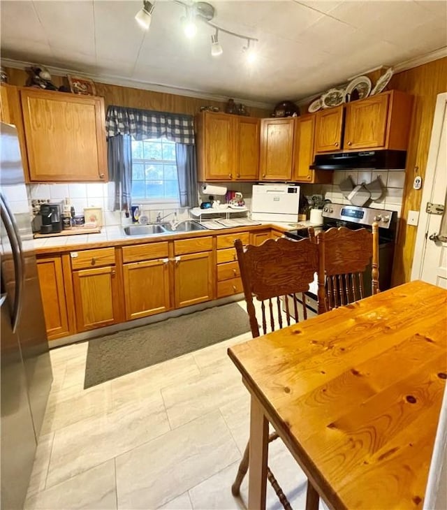 203 Adams St, Westminster, SC 29693 - kitchen featuring under cabinet range hood, stainless steel appliances, brown cabinetry, and a sink