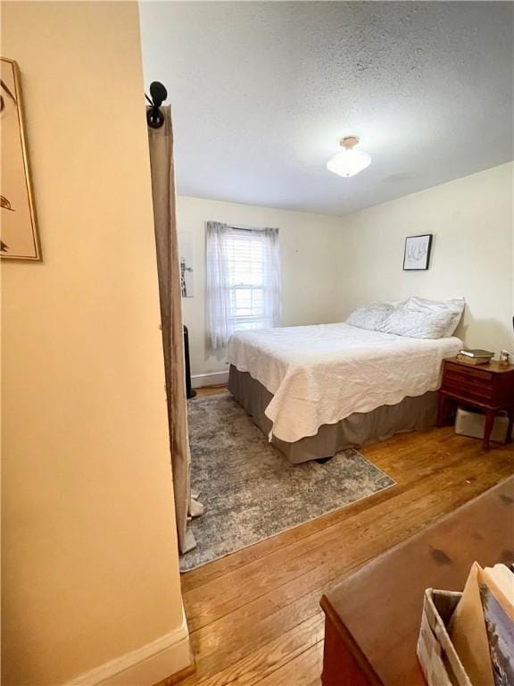 203 Adams St, Westminster, SC 29693 - bedroom with wood-type flooring and a textured ceiling