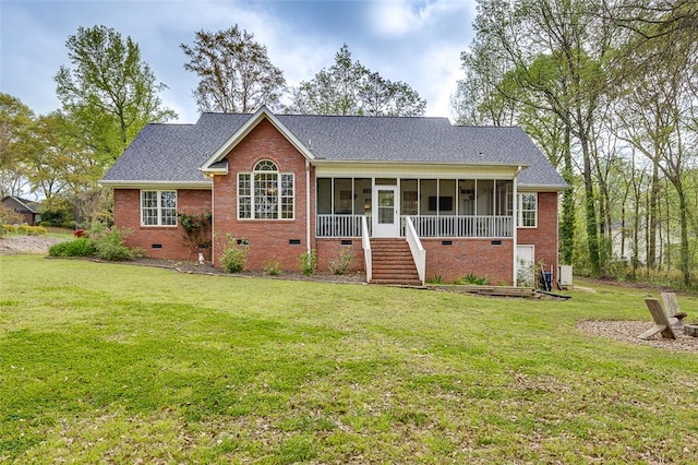 view of front of house with a sunroom, crawl space, stairway, a front yard, and brick siding