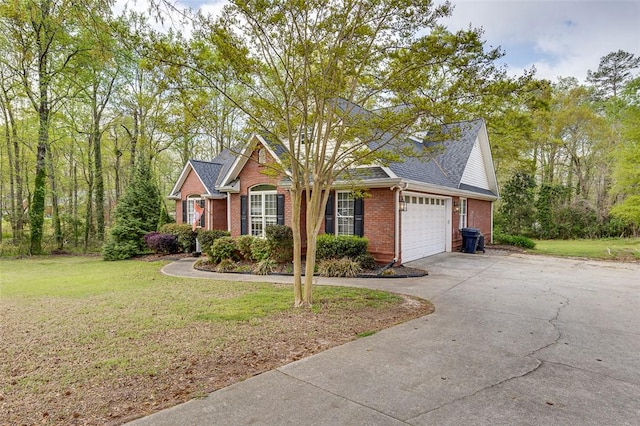 view of front of home with a front lawn, brick siding, driveway, and a garage