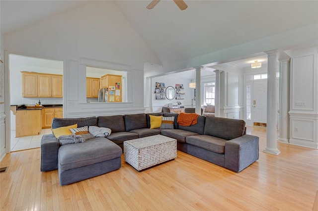 living room with light wood finished floors, high vaulted ceiling, decorative columns, visible vents, and ceiling fan