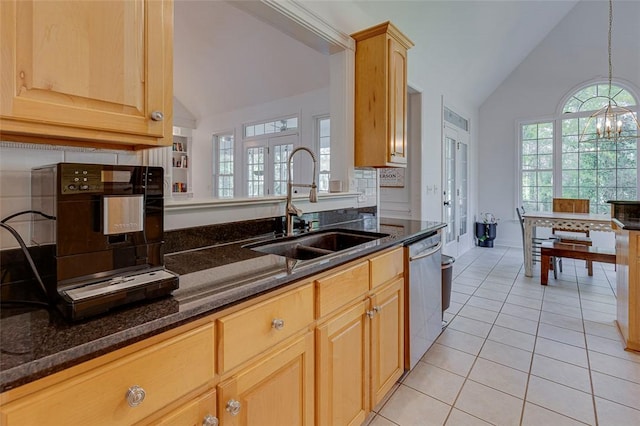 kitchen featuring dark stone countertops, a sink, dishwasher, vaulted ceiling, and tasteful backsplash
