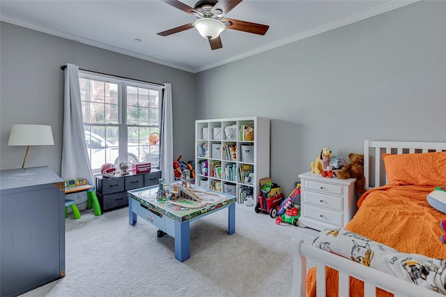 recreation room with carpet, a ceiling fan, and ornamental molding