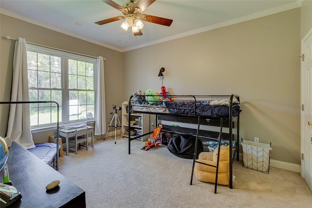 carpeted bedroom featuring baseboards, ceiling fan, and crown molding