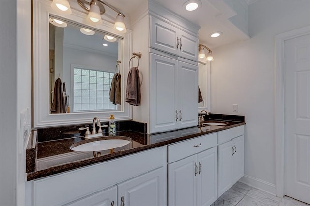 full bath with double vanity, marble finish floor, and a sink