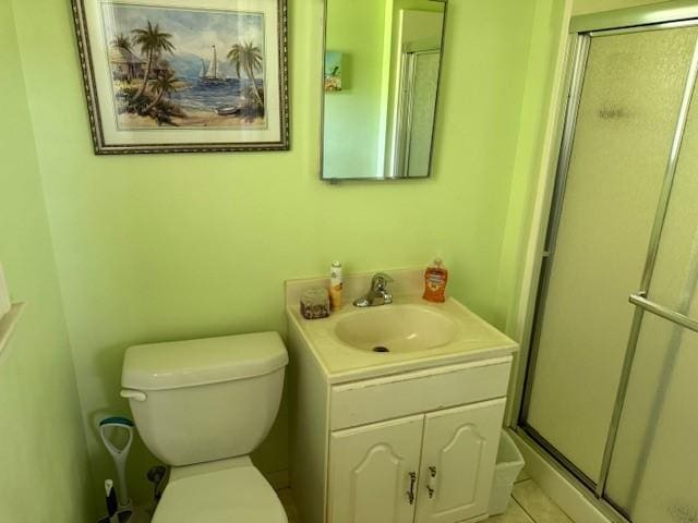 full bathroom featuring vanity, toilet, tile patterned flooring, and a shower stall