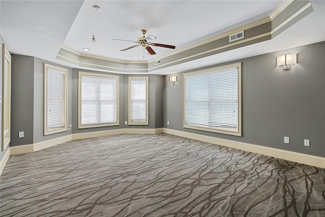 107 Amanda Dr, Anderson, SC 29621 - carpeted empty room featuring ornamental molding, visible vents, a ceiling fan, a tray ceiling, and baseboards