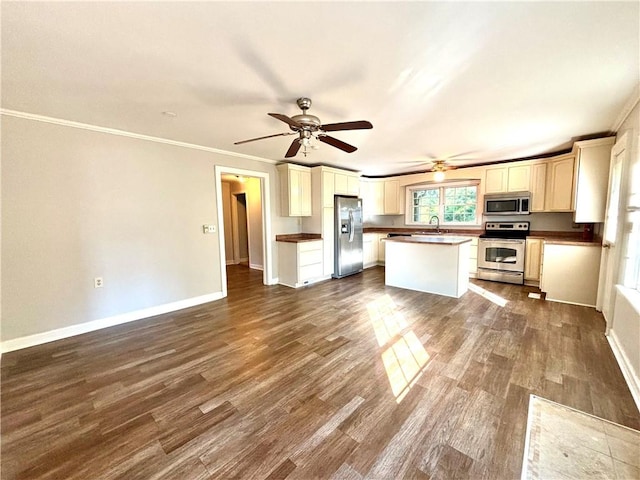 5192 Davis Cir, Anderson, SC 29625 - kitchen with stainless steel appliances, ornamental molding, dark countertops, dark wood-type flooring, and a sink