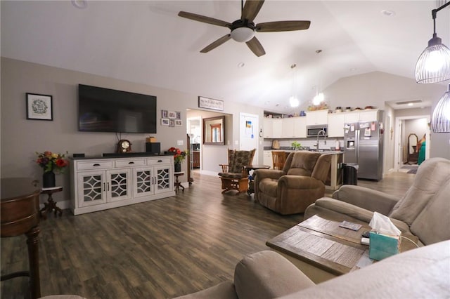 living room featuring lofted ceiling, a ceiling fan, and dark wood finished floors