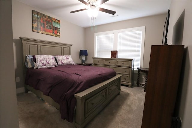 carpeted bedroom with visible vents and a ceiling fan