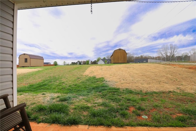 view of yard with an outbuilding and a storage unit