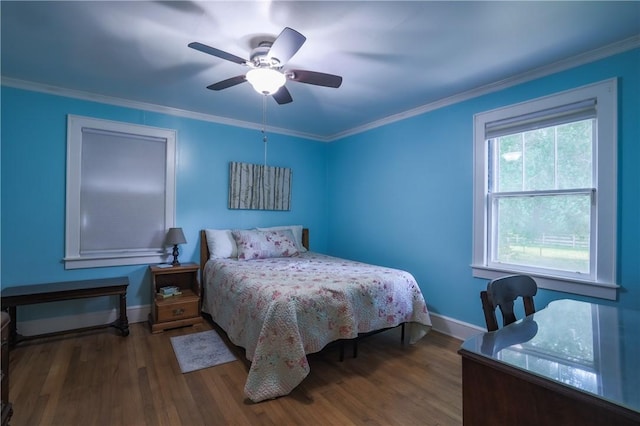 bedroom featuring ceiling fan, ornamental molding, baseboards, and wood finished floors
