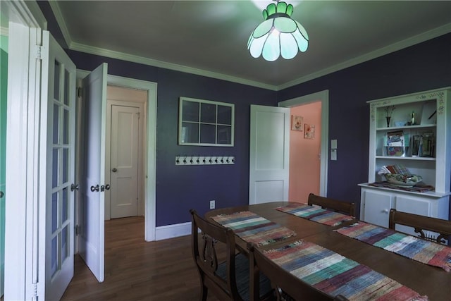 dining area featuring ornamental molding, baseboards, and wood finished floors