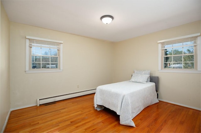 102 Norman St, Liberty, SC 29657 - bedroom with light wood-style flooring, baseboards, multiple windows, and a baseboard heating unit
