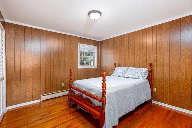102 Norman St, Liberty, SC 29657 - bedroom with a baseboard radiator, wooden walls, and wood finished floors