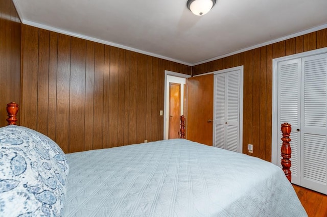 102 Norman St, Liberty, SC 29657 - bedroom with crown molding, two closets, wooden walls, and wood finished floors