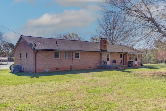 102 Norman St, Liberty, SC 29657 - rear view of property featuring a lawn, a chimney, brick siding, and crawl space